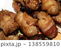 Close up of chipolatas pigs in blankets sausages wrapped in bacon on white background 138559810
