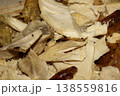 Thinly sliced seasoned cooked chicken breast on chopping board 138559816