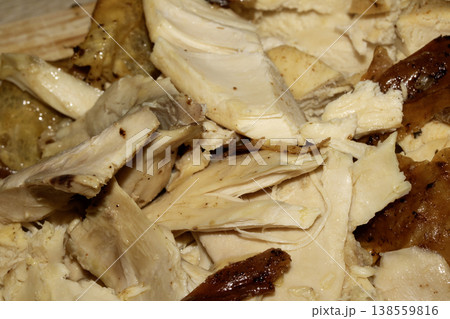 Thinly sliced seasoned cooked chicken breast on chopping board Thinly sliced seasoned cooked chicken breast on chopping board 138559816
