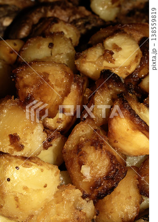 Close up of roasted vegetables crsipy potatoes side dish for Sunday roast dinner Close up of roasted vegetables crsipy potatoes side dish for Sunday roast dinner 138559819