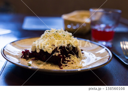 dish of beets, cheese, mayonnaise on a plate in restaurant 138560108