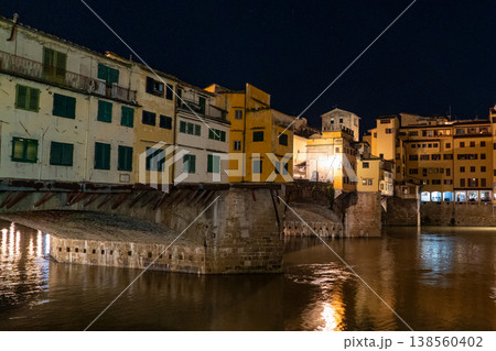 The historic Ponte Vecchio bridge in Florence, Italy, illuminated at night with reflections on the Arno River The historic Ponte Vecchio bridge in Florence, Italy, illuminated at night with reflections on the Arno River 138560402