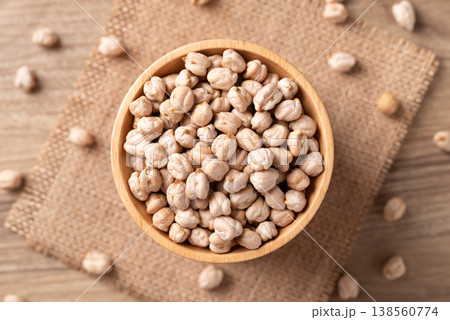 Organic raw chickpeas in a wooden bowl, healthy food ingredient, Table top view Organic raw chickpeas in a wooden bowl, healthy food ingredient, Table top view 138560774