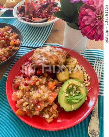 Healthy breakfast includes rabbit meat with potatoes, tomato and onion salad, avocado, and stewed vegetables. This meal is colorful and offers a variety of textures and flavors at the table Healthy breakfast includes rabbit meat with potatoes, tomato and onion salad, avocado, and stewed vegetables. This meal is colorful and offers a variety of textures and flavors at the table 138561155