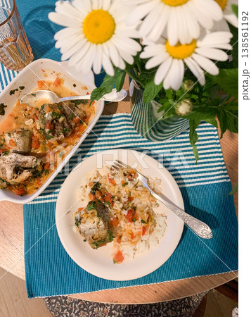 White rice with baked vegetables and baked white pollock fish, a delicious hearty lunch or dinner White rice with baked vegetables and baked white pollock fish, a delicious hearty lunch or dinner 138561192