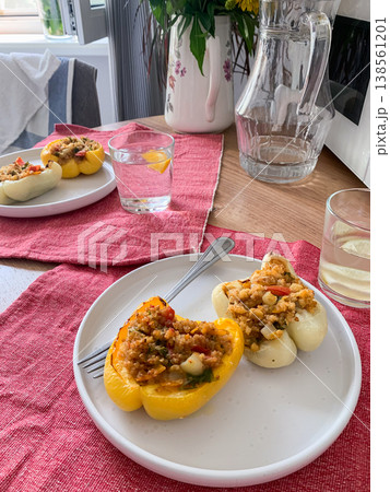 This nutritious dish of stuffed bell peppers with quinoa, lentils, and vegetables makes for a hearty, plant-based meal thats both flavorful and satisfying, perfect for any time of day 138561201