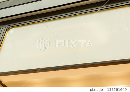 An empty storefront stands ready for branding with a blank area for signage. The glass doors and clean facade offer a space for potential retail activity An empty storefront stands ready for branding with a blank area for signage. The glass doors and clean facade offer a space for potential retail activity 138561649