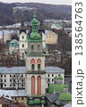 The Korniakt Tower and Dormition Church in Lviv with historic city architecture and hills, Ukraine 138564763