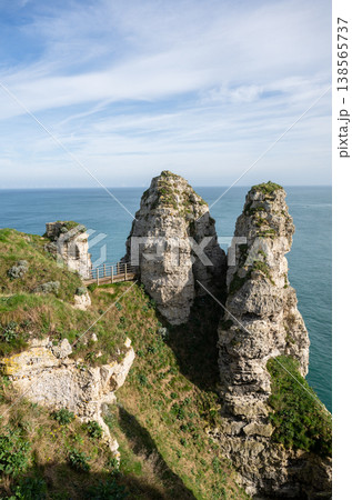 Etretat cliffs rock formations and coastal path over Atlantic ocean in Normandy France scenic landscape 138565737