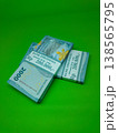 Green background holds neatly stacked banknotes. Stacks show denominations, clear and crisp. Ideal for financial, business, or economic imagery needs. No people, no animals, no plants visible here 138565795