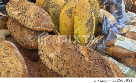 Assorted seeded artisan loaves including turmeric and multigrain bread at farmers market for bakery banner background 138565951