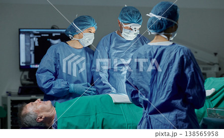 Teamwork, hospital and doctors working on a surgery for medical treatment in a theatre room. Collaboration, career and professional surgeons doing a healthcare operation on a patient in a clinic. 138565958