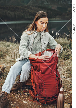 Woman, hiking and packing backpack in nature with tablet, check and thinking by lake, mountain or outdoor. Girl, luggage and trekking with bad, technology and ideas on adventure in countryside Woman, hiking and packing backpack in nature with tablet, check and thinking by lake, mountain or outdoor. Girl, luggage and trekking with bad, technology and ideas on adventure in countryside 138565984