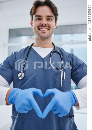 Portrait, hospital and hands in heart of doctor for medicine, surgery and working in clinic for wellness. Healthcare, emoji and man with hand sign for safety, insurance or support for medical service 138565994