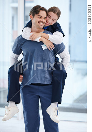 Couple, hospital and doctors piggy back for love, happy relationship and work romance in clinic. Healthcare team, dating and playful man and woman for medical service, support and medicare career Couple, hospital and doctors piggy back for love, happy relationship and work romance in clinic. Healthcare team, dating and playful man and woman for medical service, support and medicare career 138566311