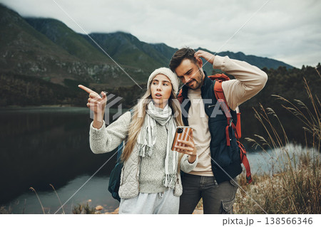 Hiking, stress and lost couple with a phone in nature for direction, map or navigation with anxiety. Backpacking, travel and people with smartphone app for location search or navigation to campsite Hiking, stress and lost couple with a phone in nature for direction, map or navigation with anxiety. Backpacking, travel and people with smartphone app for location search or navigation to campsite 138566346