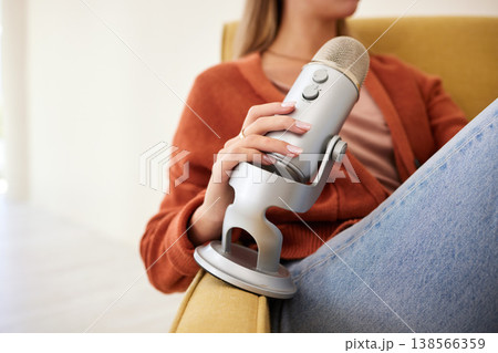 Microphone, hand and a person for a podcast, speaking or recording a voice on a sofa. Broadcast, sitting and an influencer with a mic as a speaker for communication or a platform for information Microphone, hand and a person for a podcast, speaking or recording a voice on a sofa. Broadcast, sitting and an influencer with a mic as a speaker for communication or a platform for information 138566359