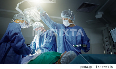 Teamwork, healthcare and surgeons working on a surgery for medical treatment in a theatre room. Collaboration, career and professional doctors doing an operation on a patient in a hospital or clinic. Teamwork, healthcare and surgeons working on a surgery for medical treatment in a theatre room. Collaboration, career and professional doctors doing an operation on a patient in a hospital or clinic. 138566410