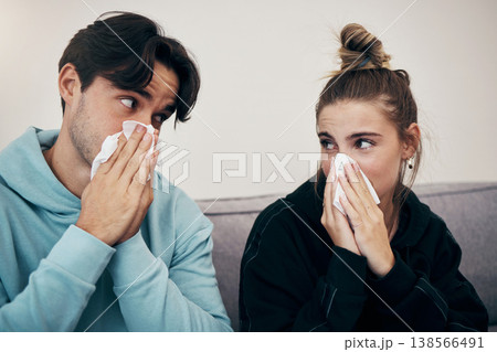 Couple, sick and virus with tissue, sofa and sickness for infection, sinus and cold symptoms. Sneeze, blowing nose and allergy in living room couch, hayfever and healthcare for disease, man and woman Couple, sick and virus with tissue, sofa and sickness for infection, sinus and cold symptoms. Sneeze, blowing nose and allergy in living room couch, hayfever and healthcare for disease, man and woman 138566491