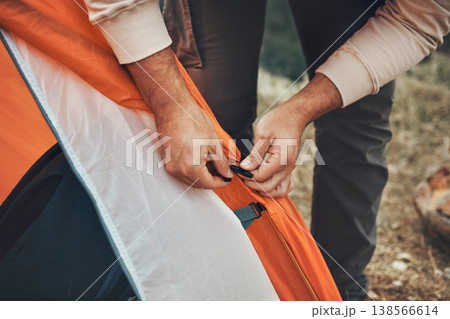 Hands, pitch tent and camping in nature on vacation, holiday or travel outdoor. Campsite, closeup and man set up shelter, tying and preparation for adventure, hiking or trekking in woods for freedom Hands, pitch tent and camping in nature on vacation, holiday or travel outdoor. Campsite, closeup and man set up shelter, tying and preparation for adventure, hiking or trekking in woods for freedom 138566614
