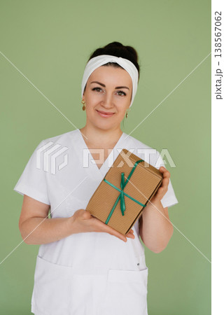 Portrait Of Happy Doctor Holding Present Box Portrait Of Happy Doctor Holding Present Box 138567062