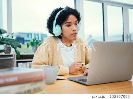 Serious, headphones and business woman on laptop working in creative startup office. Radio music, computer and professional designer planning at desk, listen to audio podcast online or reading email Serious, headphones and business woman on laptop working in creative startup office. Radio music, computer and professional designer planning at desk, listen to audio podcast online or reading email 138567099