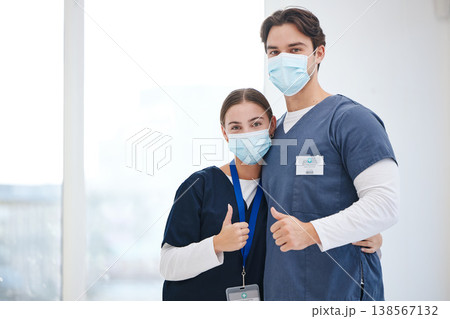 Portrait, doctors and people hug, thumbs up or vote opinion for medical support, service agreement or job well done. Safety face mask, emoji like sign and surgeon team embrace, trust and yes feedback Portrait, doctors and people hug, thumbs up or vote opinion for medical support, service agreement or job well done. Safety face mask, emoji like sign and surgeon team embrace, trust and yes feedback 138567132