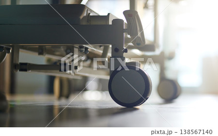 Hospital, bed and wheels of stretcher on floor, ground or interior of empty clinic with equipment. Healthcare, transport and closeup of medical wheeling chair or gurney in medical furniture and room Hospital, bed and wheels of stretcher on floor, ground or interior of empty clinic with equipment. Healthcare, transport and closeup of medical wheeling chair or gurney in medical furniture and room 138567140