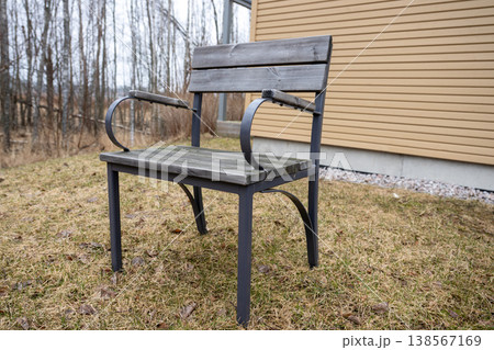 Wooden outdoor chair on backyard lawn near terrace modern garden furniture minimal lifestyle scene Wooden outdoor chair on backyard lawn near terrace modern garden furniture minimal lifestyle scene 138567169