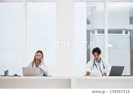 Doctors, team and hospital phone call, planning or communication for telehealth services or clinic research. Medical people working in office or reception desk with laptop, documents and mobile chat Doctors, team and hospital phone call, planning or communication for telehealth services or clinic research. Medical people working in office or reception desk with laptop, documents and mobile chat 138567318