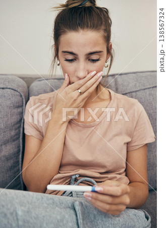 Pregnancy test, shock and sad woman on sofa in home, reading bad news and check negative exam results. Stick, surprise and pregnant mother depressed in living room for maternity, stress and anxiety Pregnancy test, shock and sad woman on sofa in home, reading bad news and check negative exam results. Stick, surprise and pregnant mother depressed in living room for maternity, stress and anxiety 138567324