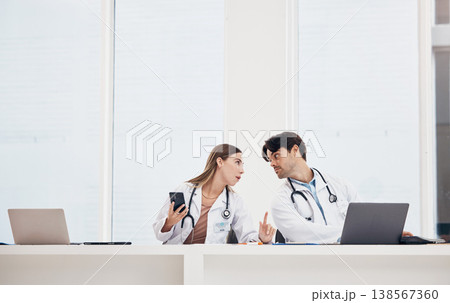 Doctors, reception desk and colleagues with phone for communication, healthcare planning or research for medical schedule in hospital. Medicine, man and woman with collaboration or working together Doctors, reception desk and colleagues with phone for communication, healthcare planning or research for medical schedule in hospital. Medicine, man and woman with collaboration or working together 138567360