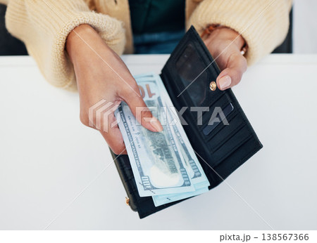 Woman, hands and wallet with money for savings, investment or payment on counter at checkout. Top view or closeup of female person with cash, bills or paper notes for finance, purchase or shopping 138567366