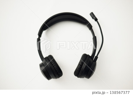 Headphones, closeup and technology, microphone for communication and sound gear on white background. Audio, radio and music, listening for podcast or wireless tech for gaming or free hand phone call 138567377