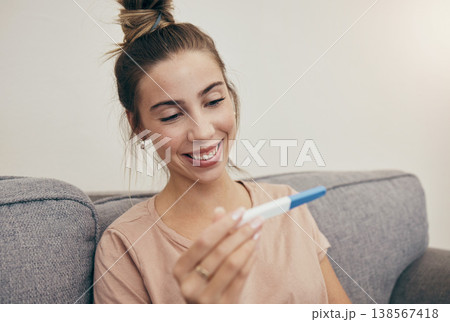 Pregnancy test, smile and woman on sofa in home, reading good news and check positive results. Pregnant, stick and happy mother in living room excited for success, future maternity and ivf fertility Pregnancy test, smile and woman on sofa in home, reading good news and check positive results. Pregnant, stick and happy mother in living room excited for success, future maternity and ivf fertility 138567418