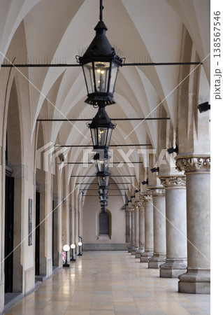 Historic European arcade with ornate lanterns and vaulted ceilings, showcasing classical architecture and a sense of timeless elegance in a public thoroughfare 138567546