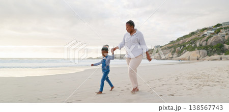Black family, mother and daughter holding hands, walk on beach and bonding with love and care outdoor. Happiness, freedom and travel, woman and young girl on holiday with trust and support in nature 138567743