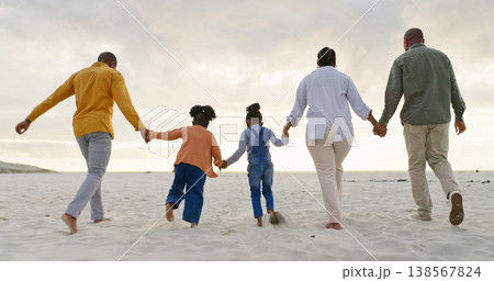 Happy, love and holding hands with black family at beach for summer, vacation and relax. Holiday, support and travel with parents and children walking on coastline for care, trust and freedom 138567824