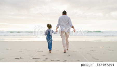 Black family, mother and daughter holding hands, beach and bonding with love and care, back view and walk outdoor. Sea, freedom and travel, woman and girl on holiday with trust and support in nature 138567894