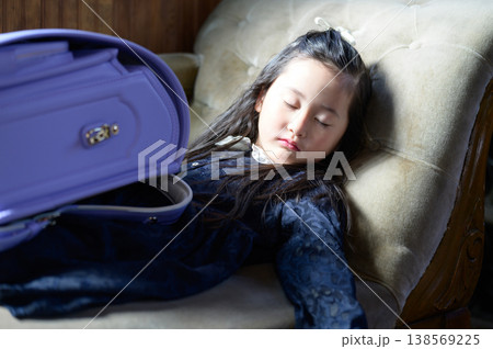 ランドセルを持ってソファで眠る日本人の女の子 ランドセルを持ってソファで眠る日本人の女の子 138569225