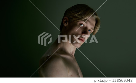 Young man with direct gaze and clean skin in soft controlled studio lighting. 138569348