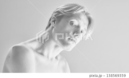 Black and white portrait of young man with soft skin and minimal clean background. 138569359