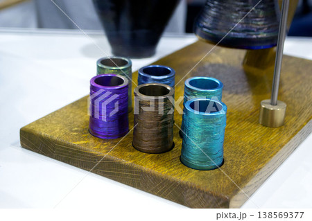 Object printing on 3D printer from melting metal thread. Model round shape printed on 3D printer from filament of molten metal. New 3D printing modeling manufacturing technology. Additive progressive Object printing on 3D printer from melting metal thread. Model round shape printed on 3D printer from filament of molten metal. New 3D printing modeling manufacturing technology. Additive progressive 138569377