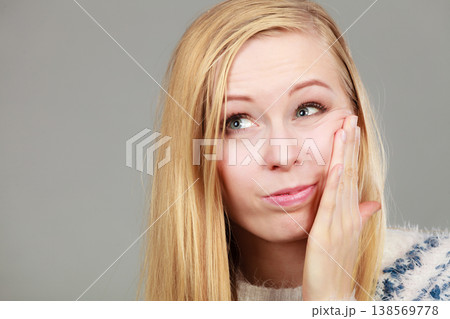 Young teenager woman thinking with hand on cheek Young teenager woman thinking with hand on cheek 138569778