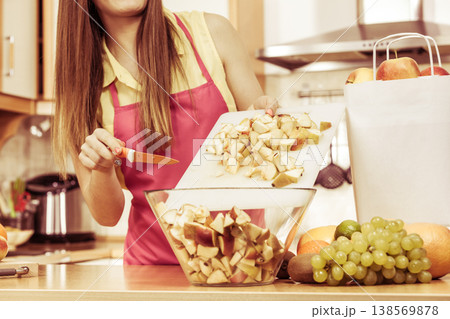 Woman housewife in kitchen cutting apple fruits Woman housewife in kitchen cutting apple fruits 138569878