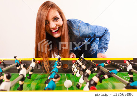 woman playing table football game woman playing table football game 138569890