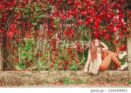 Portrait girl relaxing walking in autumnal park. 138569901