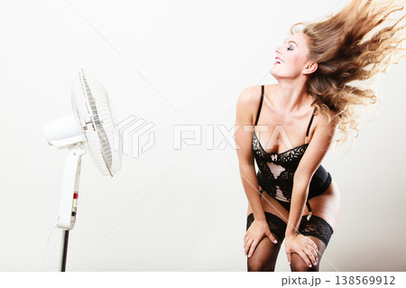 Sexy woman playing with fan. Sexy woman playing with fan. 138569912