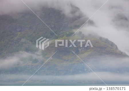 Misty mountains and fjord in Norway 138570171