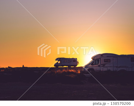 Camper cars on beach at sunset 138570200
